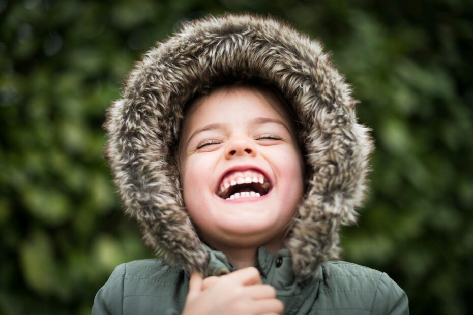 selective focus photography of child laughing